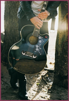 Musician holding black guitar