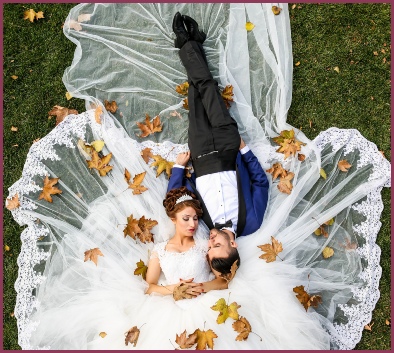 Wedding couple laying on the grass in love